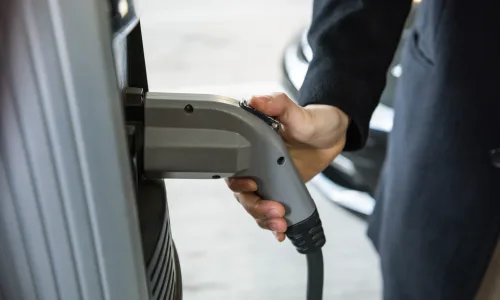 man-charging-car-electric-vehicle-charging-station